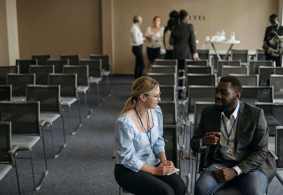 Professionals networking between conference sessions